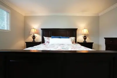 a bedroom with a bed with two lamps on tables at Destination #18 in Anaheim