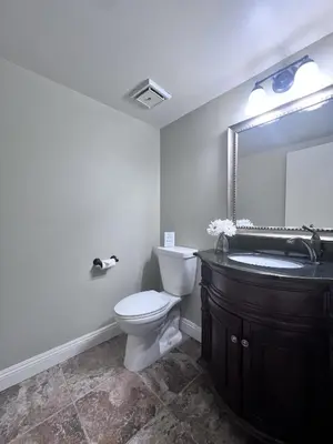 a bathroom with a toilet and a sink and a mirror at Destination #20 in Anaheim