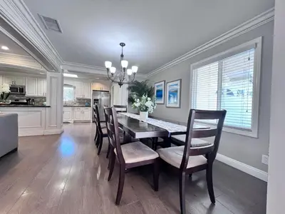 a dining room with a dining table and chairs at Destination #33 in Orange