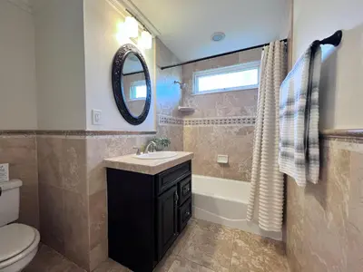 a bathroom with a sink and a toilet and a mirror at Destination #33 in Orange