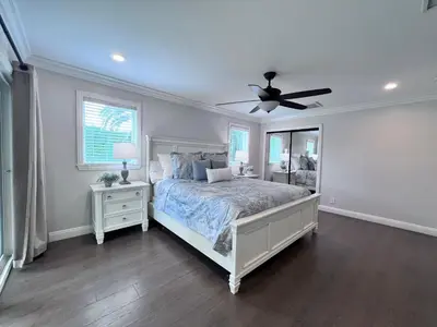 a bedroom with a bed and a ceiling fan at Destination #33 in Orange