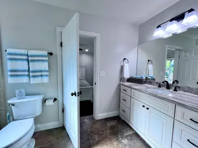 a bathroom with a sink and a toilet and a mirror at Destination #22 in Anaheim