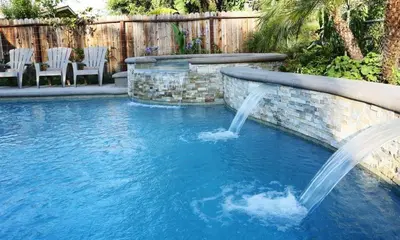 a pool with a water feature in a backyard at Destination #31 in Anaheim