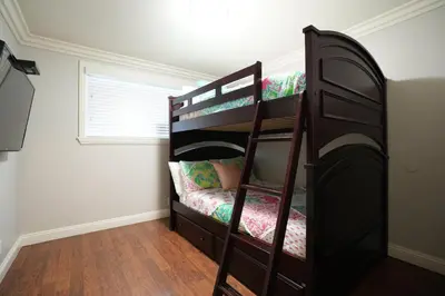 a bedroom with a bunk bed with a ladder at Destination #25 in Anaheim