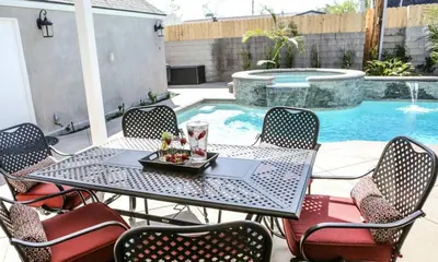 a table and chairs next to a swimming pool at Destination #34 in Santa Ana