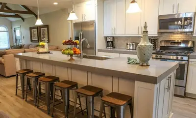 a kitchen with a large island with bar stools at Destination #34 in Santa Ana