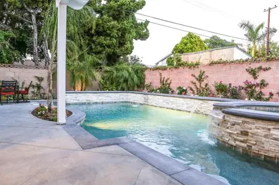 a swimming pool in a backyard with a water feature at Destination #35 in Anaheim
