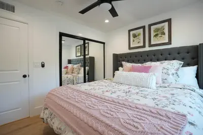 a bedroom with a large bed with a pink comforter at Destination #50 in Placentia