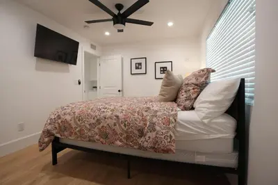 a bedroom with a bed and a ceiling fan at Destination #50 in Placentia