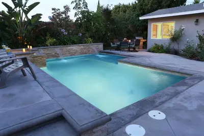 a swimming pool in the backyard of a house at Classy PoolJac Home: 2 Ensuites 34 Mile2Disney in Anaheim