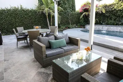 a patio with a couch and a table and a pool at Destination #39 in Orange