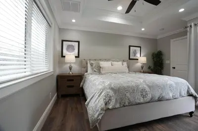 a bedroom with a bed and two lamps and a window at Destination #39 in Orange