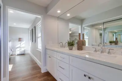 a bathroom with two sinks and a large mirror at Destination #44 in Orange