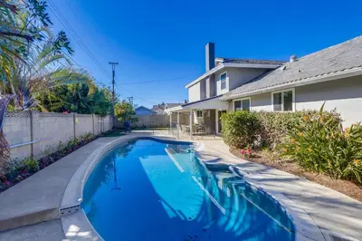 a swimming pool in a yard next to a house at Destination #44 in Orange