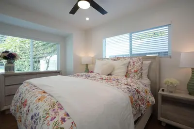 a bedroom with a bed and two windows at Destination #45 in Orange
