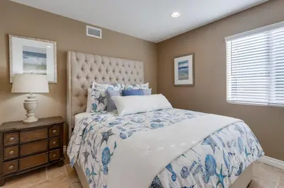 a bedroom with a blue and white bed and a window at Destination #48 in Placentia