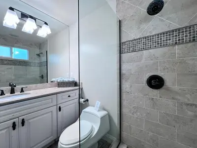 a bathroom with a shower and a toilet and a sink at Destination #01 in Anaheim