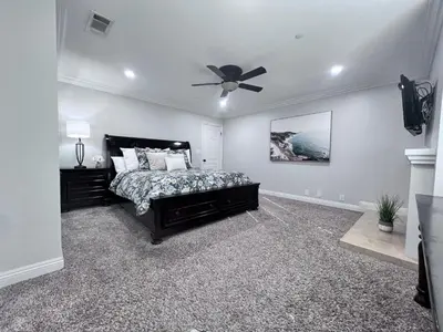 a bedroom with a bed and a ceiling fan at Destination #01 in Anaheim