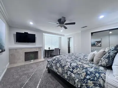 a bedroom with a bed and a flat screen tv at Destination #01 in Anaheim