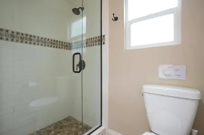 a bathroom with a shower with a toilet and a window at Destination #14 in Anaheim