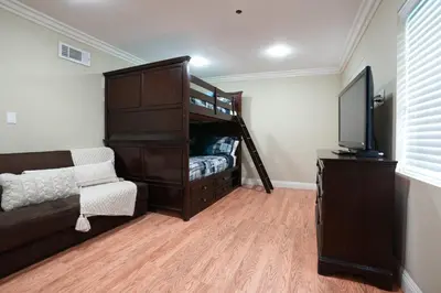 a bedroom with a bunk bed and a tv at Destination #14 in Anaheim