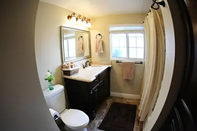 a bathroom with a sink and a toilet and a mirror at Destination #14 in Anaheim