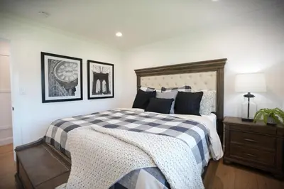 a bedroom with a bed with a checkered blanket at Destination #47 in Orange