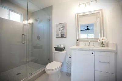 a bathroom with a shower and a toilet and a sink at Destination #47 in Orange