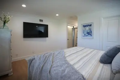 a living room with a flat screen tv on a wall at Destination #47 in Orange