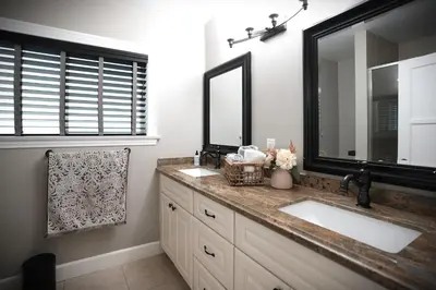 a bathroom with two sinks and a large mirror at Destination #51 in Santa Ana
