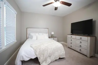 a bedroom with a bed and a flat screen tv at Destination #51 in Santa Ana