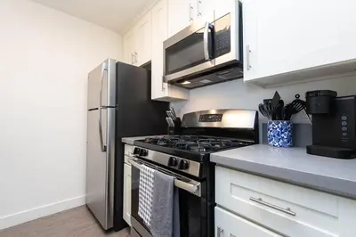 a kitchen with a stove and a microwave at Hollywood 1Bed Apt w Rooftop pool & Panoramic View in Los Angeles