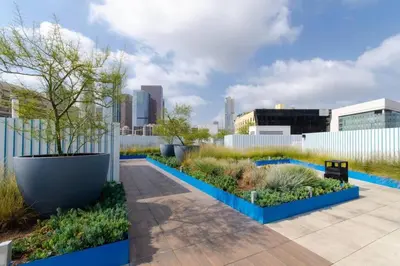 a garden with blue planters and plants at Cozy 3bed Condo with balcony & a rooftop pool in Los Angeles
