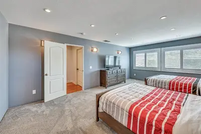 a bedroom with two beds and a television in it at Large Rancho Cucamonga Home 5 Mi to Red Hill Park in Rancho Cucamonga