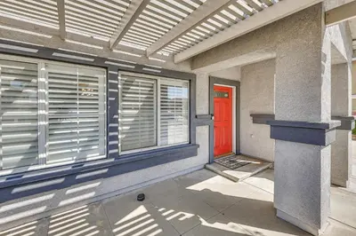 a red door on the side of a building with windows at Large Rancho Cucamonga Home 5 Mi to Red Hill Park in Rancho Cucamonga
