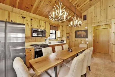 a kitchen with a long wooden table and chairs at Bruin Chalet Big Bear~ Cozy Single Level Retreat Cottage~ in Big Bear Lake