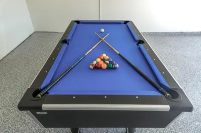 a pool table with three balls on it at Family Getaway Villa to Disneyland! Sleeps up to 22 persons w Game Room, Pool Table & EV Friendly in Midway City