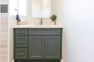 a bathroom with a green cabinet and a sink at Family Getaway Villa to Disneyland! Sleeps up to 22 persons w Game Room, Pool Table & EV Friendly in Midway City