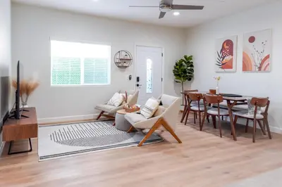 a living room with a couch and a table at Family Getaway Villa to Disneyland! Sleeps up to 22 persons w Game Room, Pool Table & EV Friendly in Midway City
