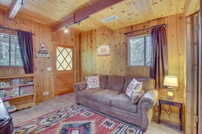a living room with a couch in a cabin at Woodsy Lake Arrowhead Cabin with Fire Pit Table in Lake Arrowhead