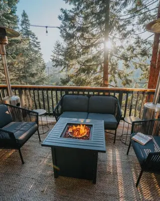 a patio with a fire pit on a deck at Lightfoot Cabin Mid-Century Perfect Romantic Getaway Hot Tub Sauna in Running Springs