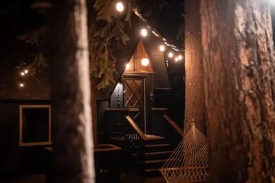 a room with stairs and lights on a wall at Lightfoot Cabin Mid-Century Perfect Romantic Getaway Hot Tub Sauna in Running Springs