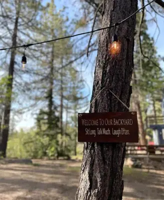 a sign attached to a tree in a park at The Scandia “A-Frame Chalet” Fireplace & Hot tub in Running Springs