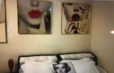a bedroom with a bed with three pictures on the wall at Luxury 2 Bedroom Suite Apartment in Koreatown in Los Angeles