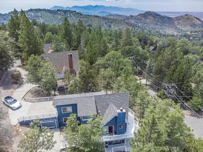 an aerial view of a blue house with a car at Classic AFrame - Fireplace - GameRoom - 2 Decks View in Lake Arrowhead