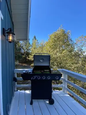 a laptop computer sitting on a grill on a porch at Classic AFrame - Fireplace - GameRoom - 2 Decks View in Lake Arrowhead