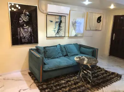 a living room with a blue couch and a table at Stylish Apartment in Koreatown! Central Location!! in Los Angeles