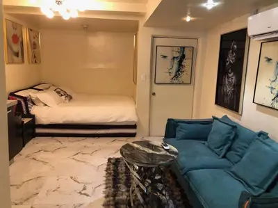 a living room with a couch and a bed at Stylish Apartment in Koreatown! Central Location!! in Los Angeles