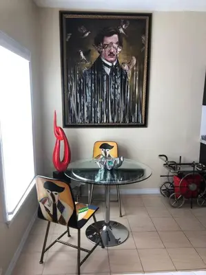 a dining room with a table and a picture of a man at Murano Studio in the Heart of Koreatown in Los Angeles