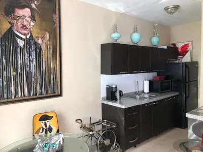 a kitchen with a picture of a man on the wall at Murano Studio in the Heart of Koreatown in Los Angeles
